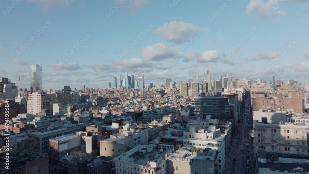Sunny day in large city. Aerial view of town development with modern downtown skyscrapers in background. Manhattan, New York City, USA Sunny day in large city. Aerial view of town development with modern downtown skyscrapers in background. Manhattan, New York City, USA