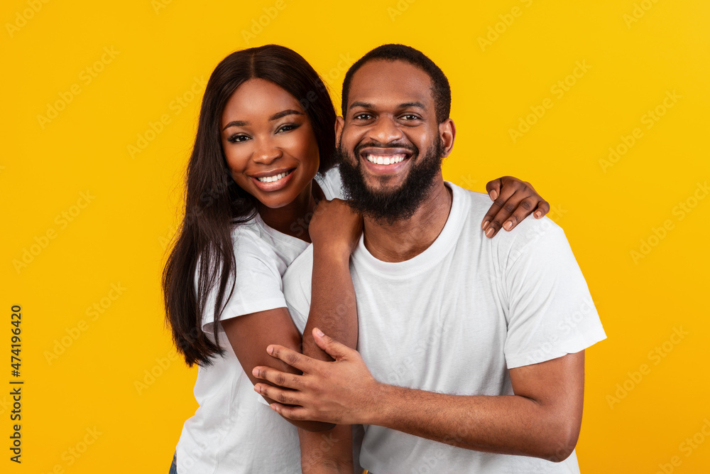 Fototapeta premium African American bearded man cuddling with his woman