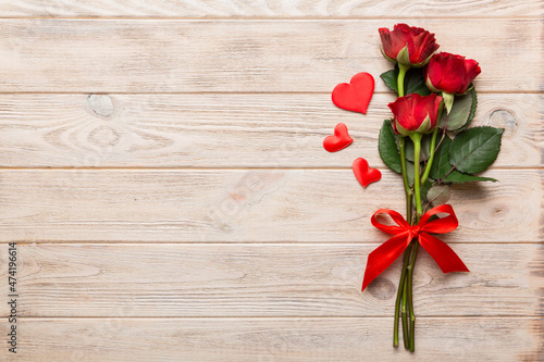 Valentine day composition with rose flower and red heart on table. Top view  flat lay  copy space Holiday concept