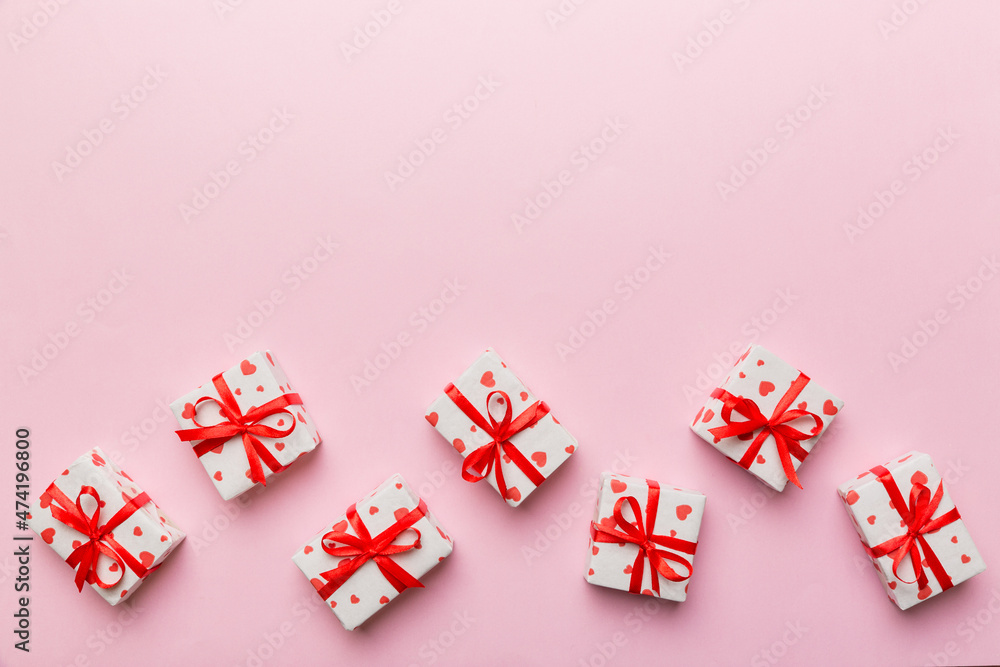 Valentine day composition: red gift box with bow and heart. Christmas present. View from above. Space for text. Holday greeting card Valentine day composition: red gift box with bow and heart. Christmas present. View from above. Space for text. Holday greeting card