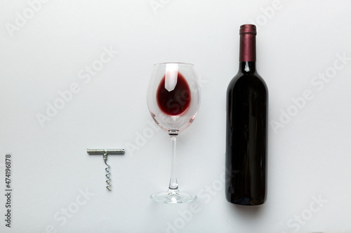 Flat lay composition with corkscrew, bottle of wine and elegant glass on colored table. Flat lay, top view wth copy space