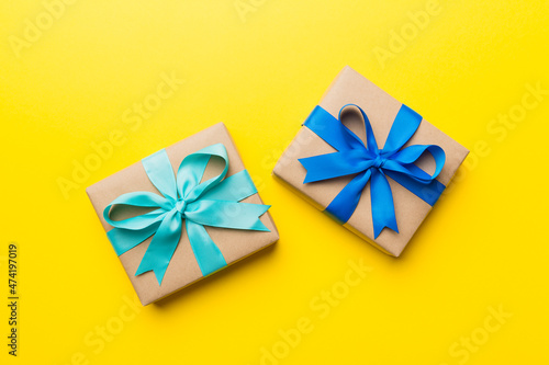 Holiday present box over colored background, top view © sosiukin