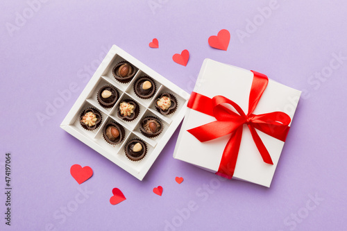 Delicious chocolate pralines in red box for Valentine's Day. Heart shaped box of chocolates top view with copy space © sosiukin