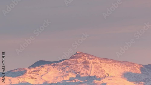 Snowy Sierra nevada veleta peak in Granada, Andalusia, Spain during sunset timelapse