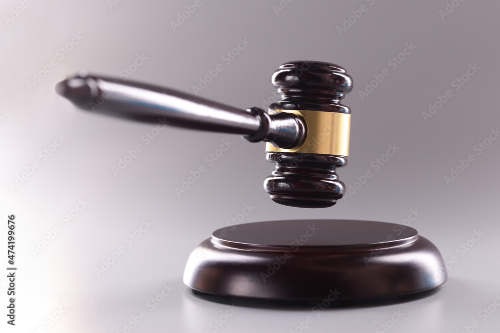 Wooden judge gavel on a gray background