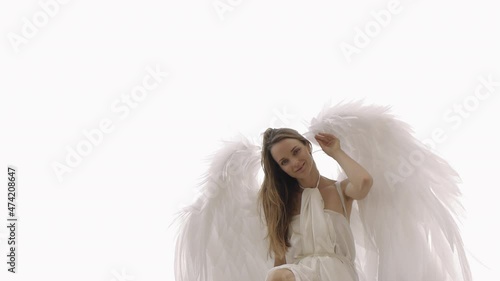Female model in the image of an angel with wings