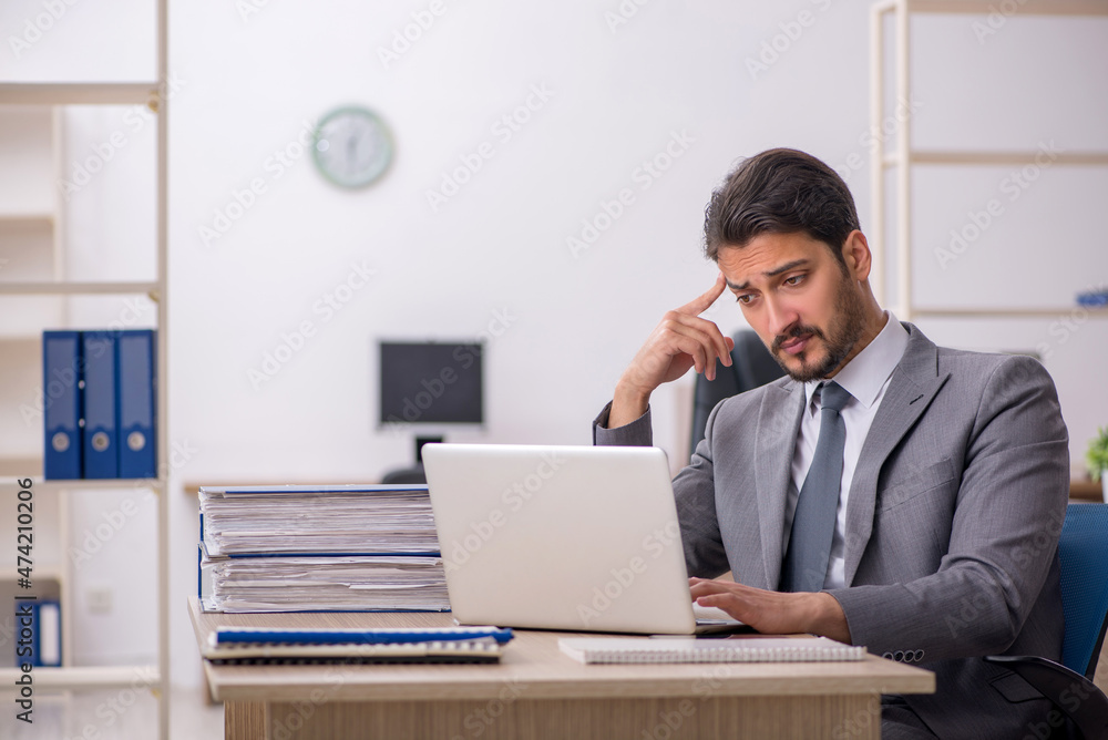 Young male employee working in the office Young male employee working in the office
