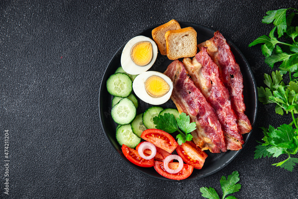 English breakfast bacon, egg, tomato, cucumber, toast bread healthy meal diet snack on the table copy space food background rustic. top view