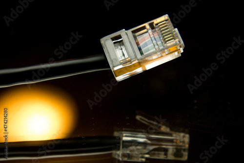 Artistic shot of an ethernet cable and its reflection