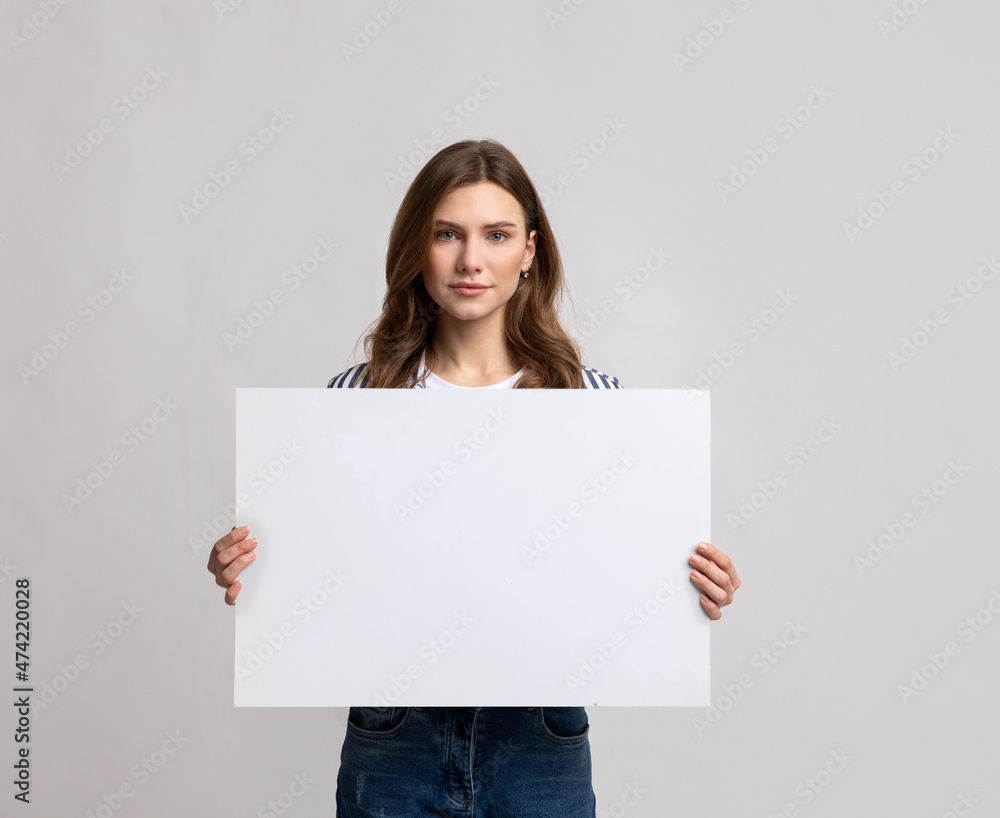 Place For Your Ad. Beautiful Young Woman Holding Blank Placard