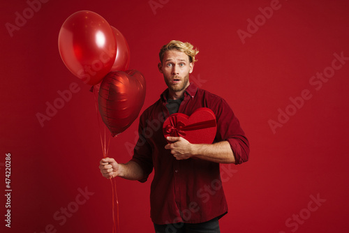 White surprised man posing with balloons and heart gift box © Drobot Dean
