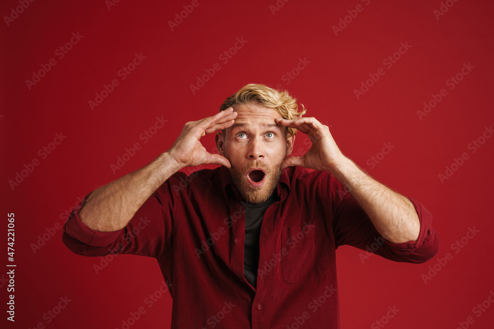 White bearded man expressing surprise while holding his head White bearded man expressing surprise while holding his head