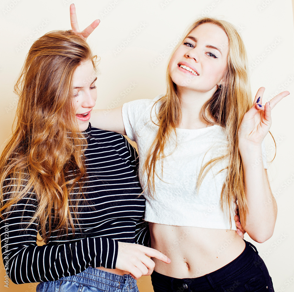 best friends teenage girls together having fun, posing emotional on white background, besties happy smiling, lifestyle people concept close up. making selfie
