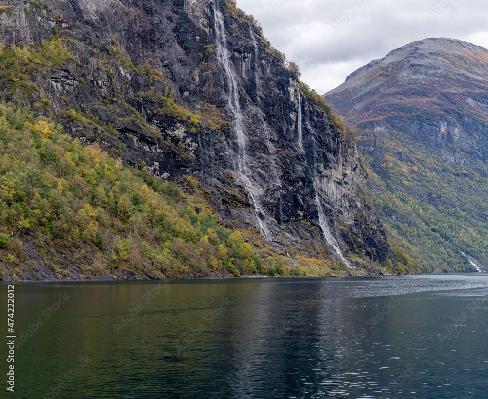 The Seven Sisters waterfall (Norwegian: De Syv Søstrene, Knivsflåfossen) located along the Geirangerfjorden in Stranda Municipality in Møre og Romsdal county, Norway. The Seven Sisters waterfall (Norwegian: De Syv Søstrene, Knivsflåfossen) located along the Geirangerfjorden in Stranda Municipality in Møre og Romsdal county, Norway.