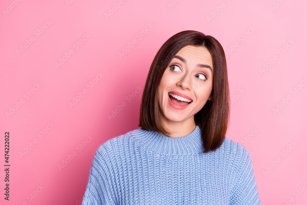 Fototapeta premium Portrait of attractive amazed curious cheery girly brown-haired girl looking aside copy space isolated over pink pastel color background