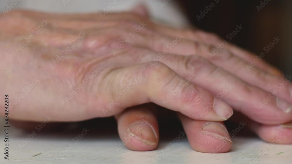 Close-up of hands of folded wrinkled elderly man. Old age health preservation theme. Emotions of the elderly. Thinking senior citizen. Selective focus Close-up of hands of folded wrinkled elderly man. Old age health preservation theme. Emotions of the elderly. Thinking senior citizen. Selective focus