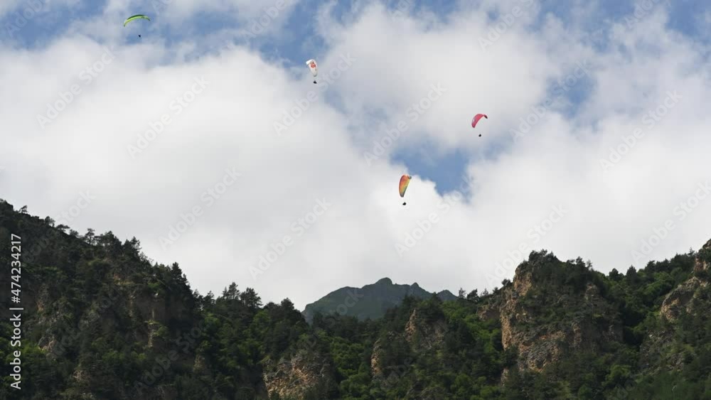 People fly paragliders in the mountains People fly paragliders in the mountains