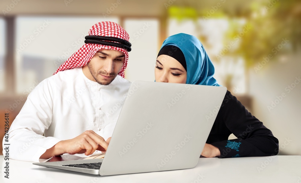 Two arabic employees Proud of their achievement done in the laptop