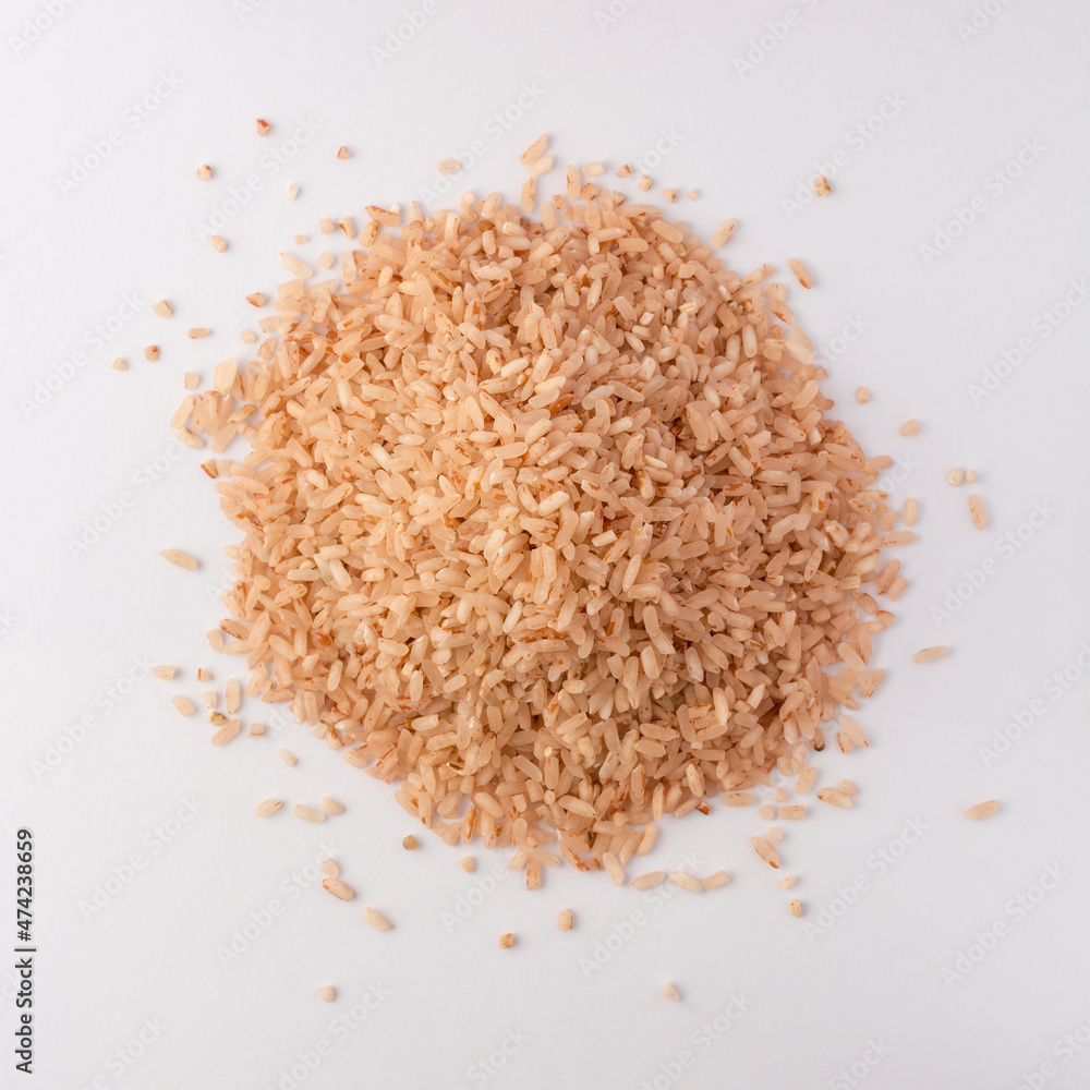 pile of whole grain brown rice isolated on white background, closeup view taken from above pile of whole grain brown rice isolated on white background, closeup view taken from above