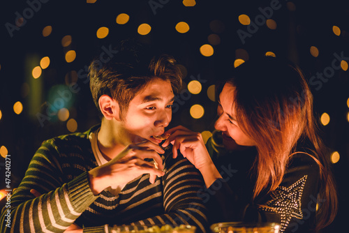 young Asian couple in night...