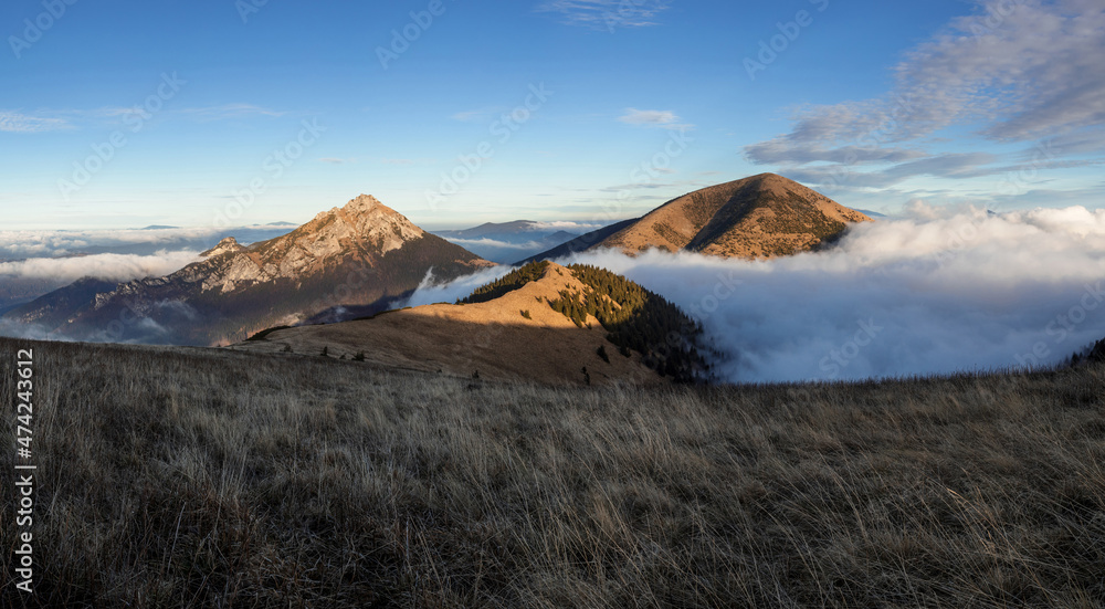 Mala Fatra, Lesser Fatra, Slovakia, Europe. Velky Rozsutec and Stoh, mountain and peak lit by evening light at golden hour. Landscape and nature in autumn and fall. Clouds and inversion in the walley. Mala Fatra, Lesser Fatra, Slovakia, Europe. Velky Rozsutec and Stoh, mountain and peak lit by evening light at golden hour. Landscape and nature in autumn and fall. Clouds and inversion in the walley.