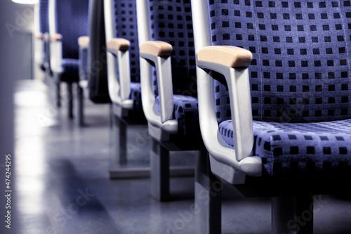 Empty seats in regional train in Europe colored in the new Veri Peri color of the year 2022.