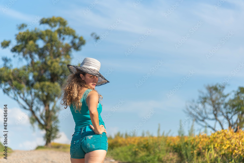 Fototapeta premium Blonde Brazilian woman posing for photos in rural landscape