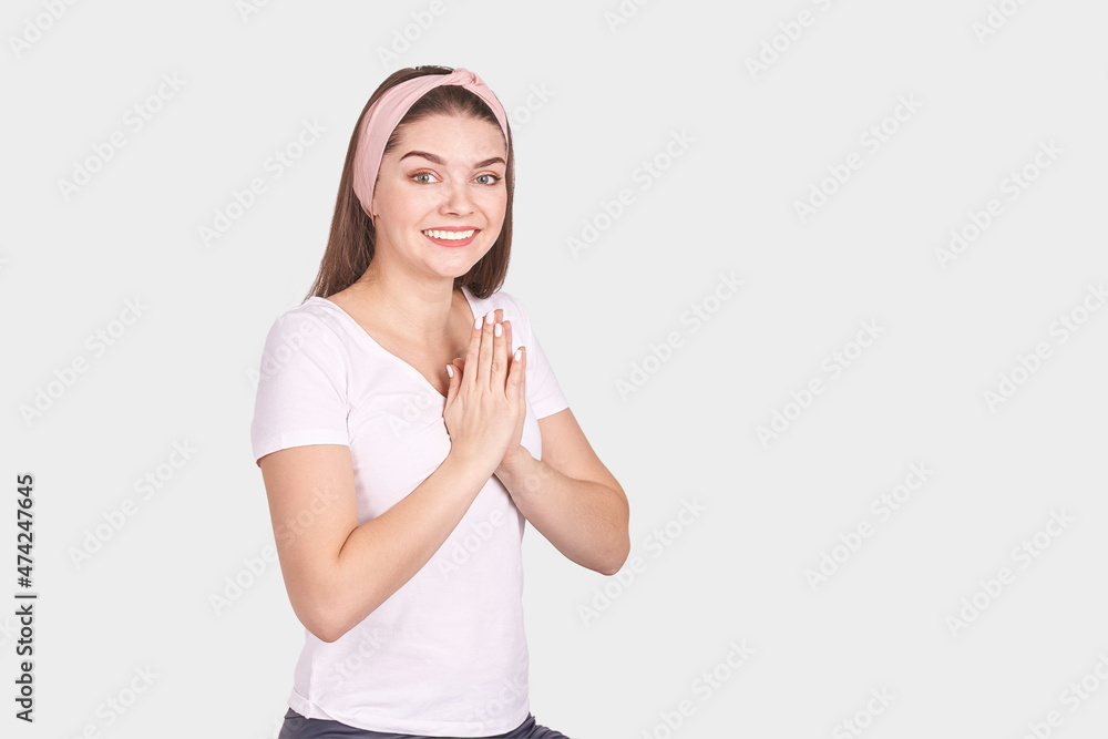 Pretty young woman gesture. Studio portrait. Female person. Isolated background. Morning bathroom routine. Pray pose. Happy medication emotion. Fitness practice. Hand yoga mudra