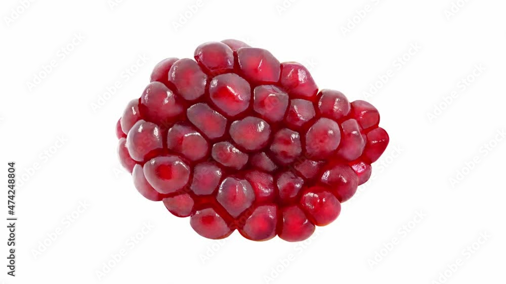 Pomegranate fruit inner red seeds close up, rotating on white background, top view. Pomegranate fruit inner red seeds close up, rotating on white background, top view.