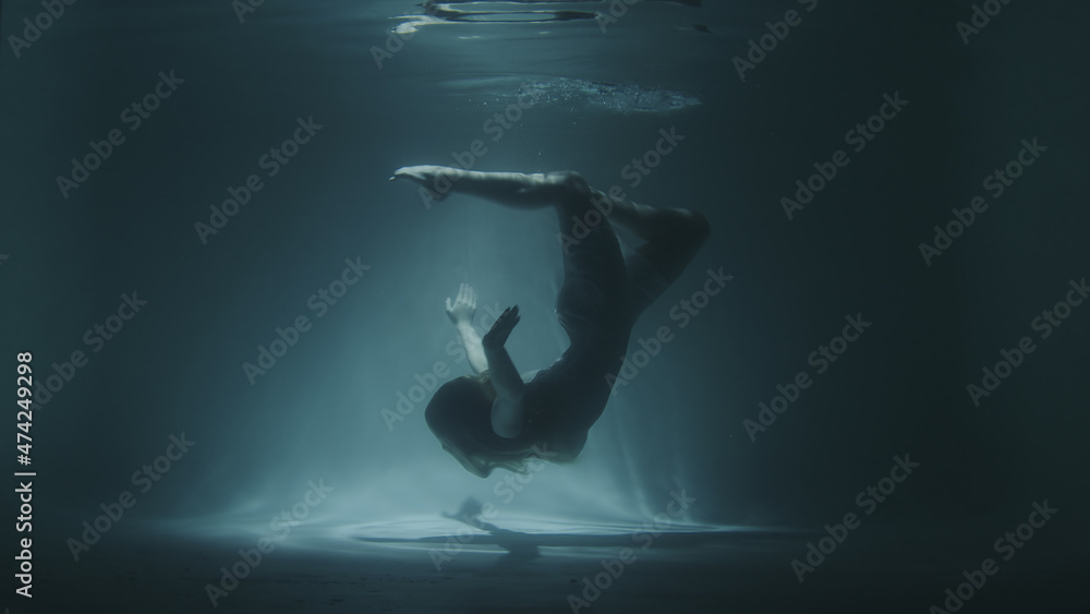 underwater gymnastics of a beautiful girl in a white dress underwater gymnastics of a beautiful girl in a white dress