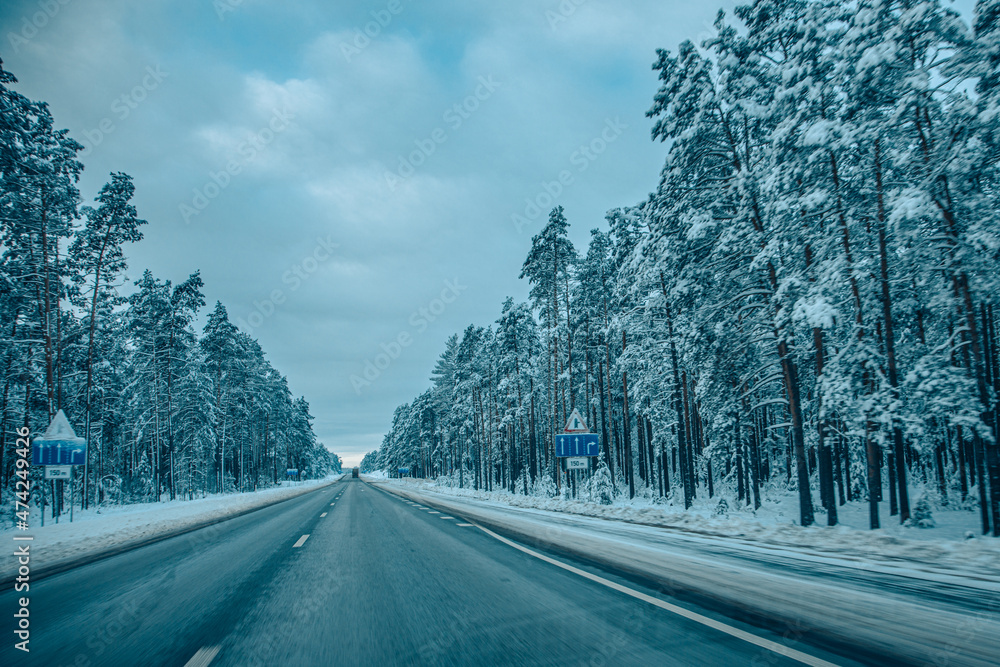 Winter asphalt road. Winter road and trees with snow and Latvian landscape. Soft focus on photos. Winter asphalt road. Winter road and trees with snow and Latvian landscape. Soft focus on photos.