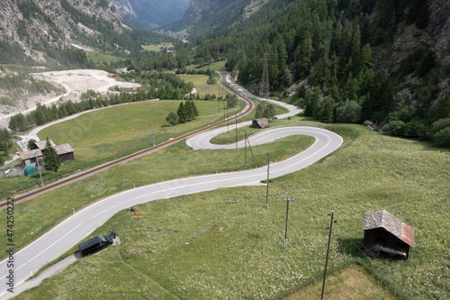 road and curves over valley from aerial view photo