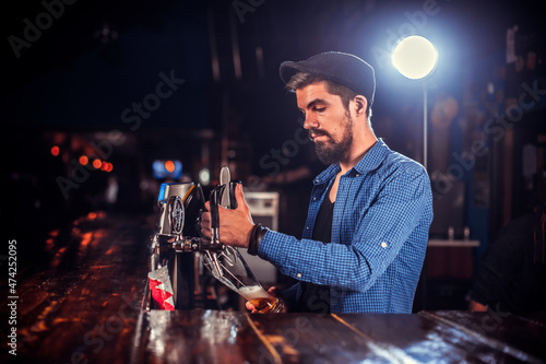 Focused tapster surprises with its skill bar visitors at the night club photo