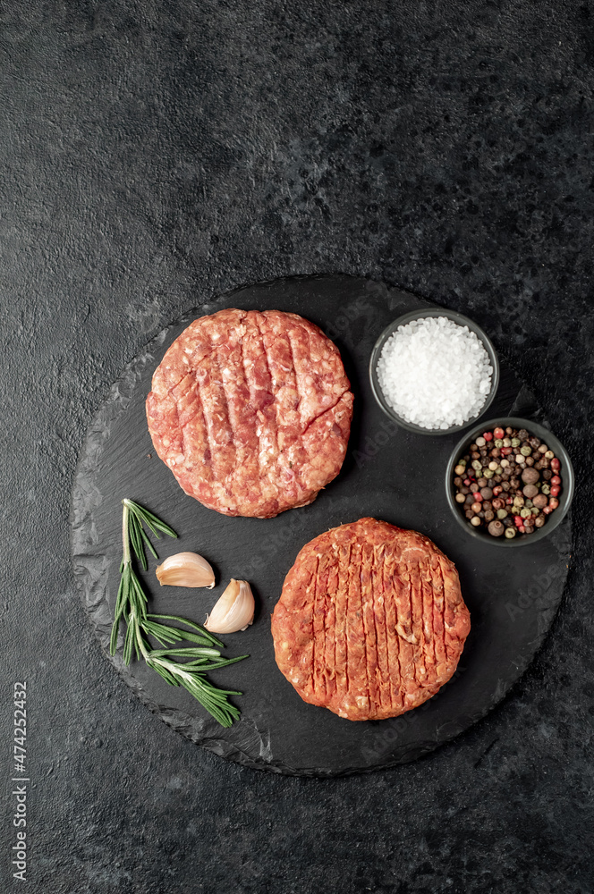 raw cutlets for making burger on stone background raw cutlets for making burger on stone background