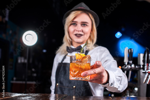 Girl barman concocts a cocktail in the brasserie photo