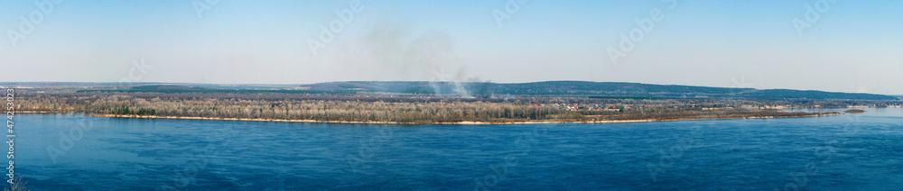Panoramic shot with a view of the Volga River from the mountain in the village of Shiryaevo in early spring. Located near the city of Samara, Russia. Samarskaya Luka National Park.