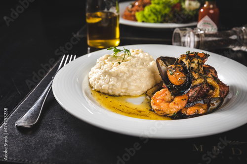 Perfect Seafood Menu Dish Plate Food Octopus Salmon, Shrimp Risotto Pasta Vegetables Salad Fish on a Dark Background