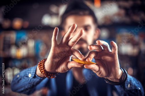 Barman makes a cocktail in the saloon photo