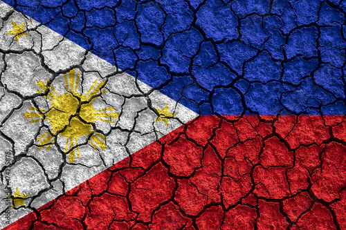Republic of the Philippines flag on dry earth ground texture background