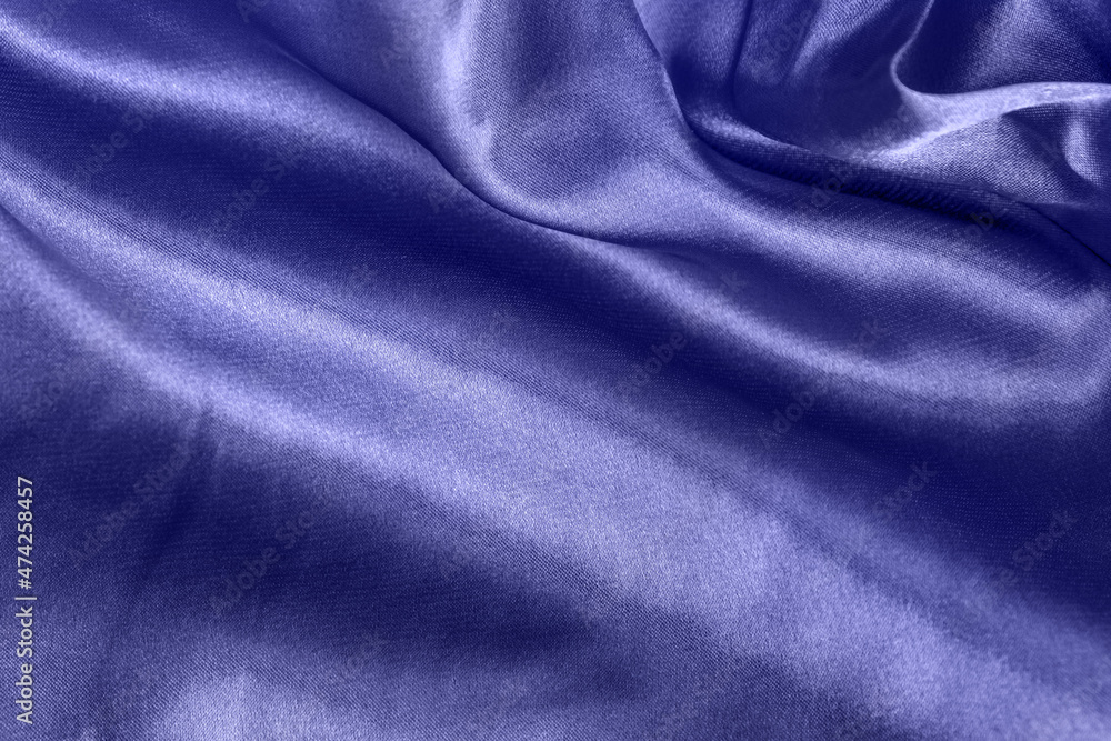 Fototapeta premium Color of the year 2022 elegant smooth silk or satin folds closeup. Cloth texture background. Abstract wallpaper. Trendy violet backdrop for web design. Luxury twisted fabric backplate