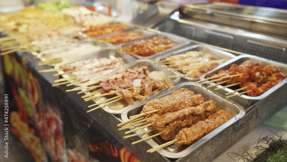 Grilled squid on a charcoal stove in night markets.Fresh seafood on street foods Grilled squid on a charcoal stove in night markets.Fresh seafood on street foods