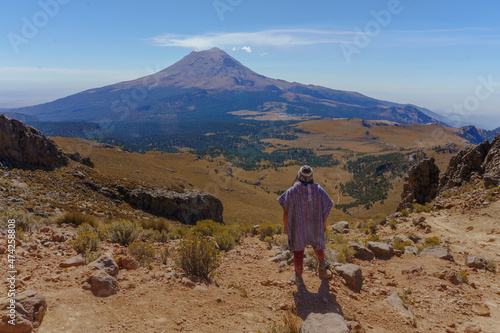 men Hiker Looking At Steaming Volcano