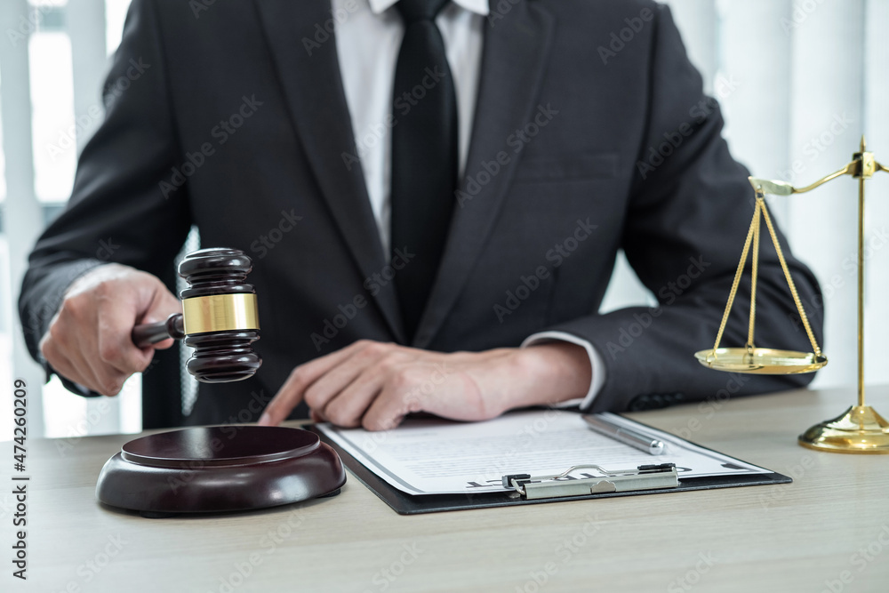 Male lawyer working with legal case document contract in office Male lawyer working with legal case document contract in office