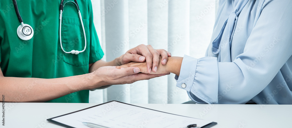 Hand of doctor touching patient reassuring for encouragement and empathy to support while medical examination on the hospital Hand of doctor touching patient reassuring for encouragement and empathy to support while medical examination on the hospital