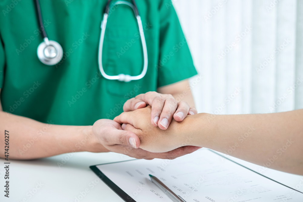 Hand of doctor touching patient reassuring for encouragement and empathy to support while medical examination on the hospital Hand of doctor touching patient reassuring for encouragement and empathy to support while medical examination on the hospital