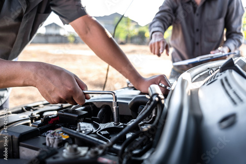 Technician team working of car mechanic in doing auto repair service and maintenance worker repairing vehicle with wrench, Service and Maintenance car check