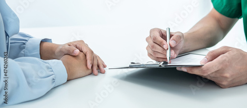 Doctor presenting with the patient and checking results on report and prescription about the problem of illness and recommended treatment method