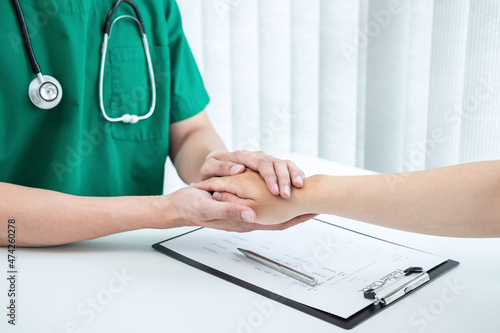 Hand of doctor touching patient reassuring for encouragement and empathy to support while medical examination on the hospital