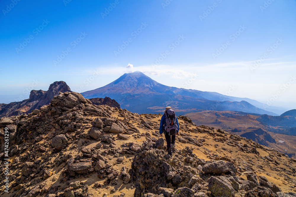 A man climbing a hill in the mountains of iztaccihuatl volcano