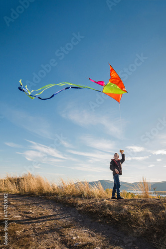 A boy of 10 years old with a kite against the sky. Bright sunny day. Flight